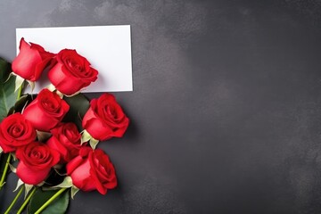 A lush bouquet of vibrant red roses accompanied by a blank white card, ready for a personal message.