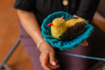 Creative aging. Asian senior's knitting masterpiece. A delightful elderly woman enjoys her...