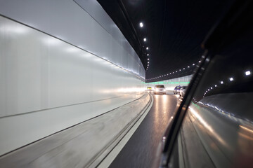 Movement in car inside tunnel of modern city highway, motion blur