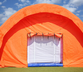 Orange pneumoframe modular tent in a field hospital at the stadium