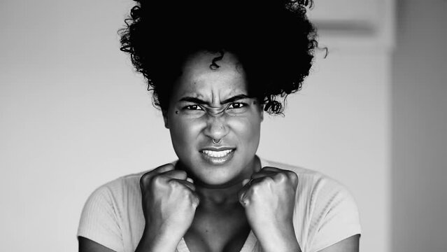 Furious African American Lady in 20s Showing Powerful Emotion, Assertive and Emotional Expression in High-Contrast Monochrome