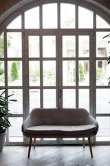 Sofa on the background of a window with a wooden frame and small glasses. Aesthetics and d cor - 751619999