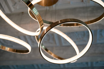 Chandelier on the concrete ceiling. Circles or rings. Luminaire design - 751620506