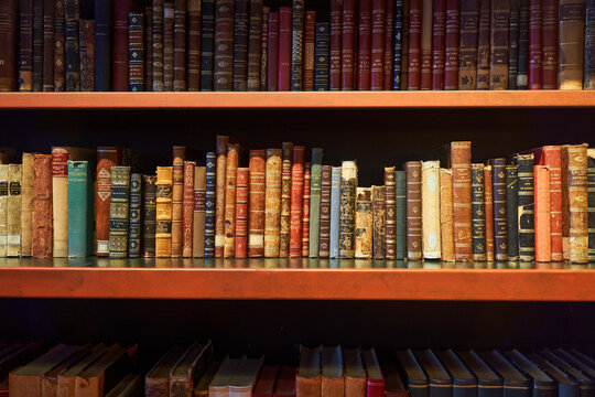 An image of a bookcase with shelves filled with various publications, creating a collection of rectangular shapes made of composite material in a library