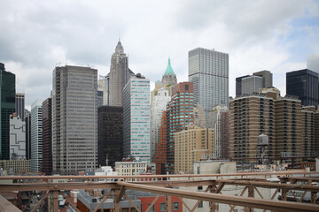 View of the architecture skyscrapers of Manhattan from Brooklyn Bridge