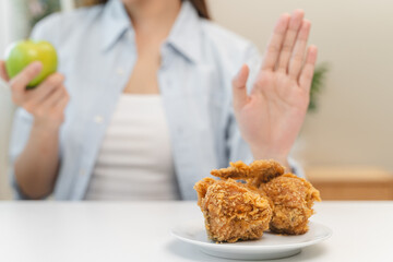 Diet food loss weight concept, Hand of woman pushing fast food away and avoid to eat fried chicken...