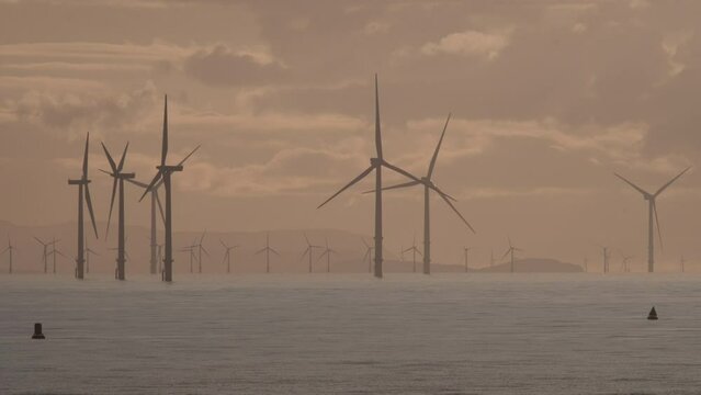 Burbo Bank Offshore Wind Farm seen from Formby beach with dramatic sky in background 