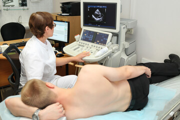  Woman doctor examining patient with abdomen ultrasound in exam room multidisciplinary Clinic Center Endosurgery and Lithotripsy