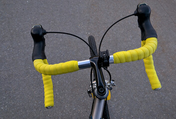 bike handlebar detail with bright yellow bar tape (bicycle cockpit, cycling) integrated shifters,...
