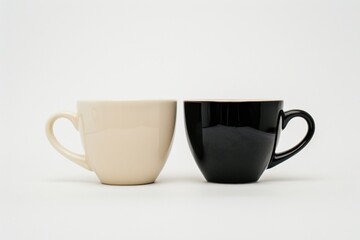 Two coffee cups, one beige and one black, against a white background.