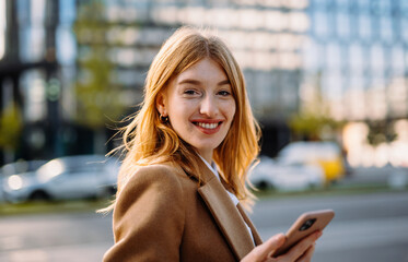 Portrait beautiful realtor strolling street and looking camera with smile