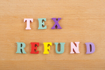 TEX REFUND word on wooden background composed from colorful abc alphabet block wooden letters, copy space for ad text. Learning english concept.