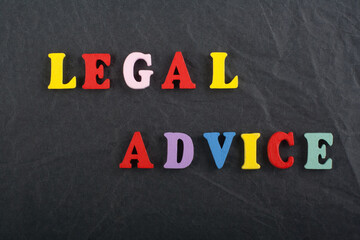 LEGAL ADVICE word on black board background composed from colorful abc alphabet block wooden...