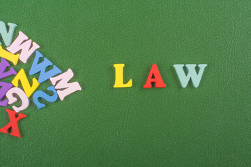 LAW word on green background composed from colorful abc alphabet block wooden letters, copy space for ad text. Learning english concept.