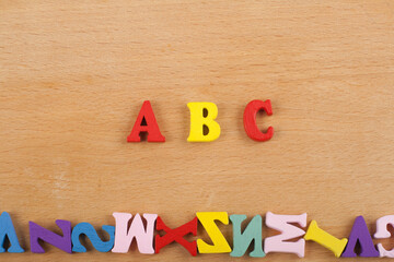ABC word on wooden background composed from colorful abc alphabet block wooden letters, copy space for ad text. Learning english concept.