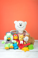 Collection of colorful toys on an orange background. Kids toys.