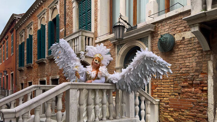 Venice Carnival. People in Venetian carnival masks and costumes on streets of Venice, Italy, Europe...