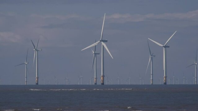 Burbo Bank Offshore Wind Farm seen from crosby beach with clouds in background