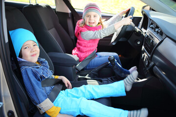  boy and girl playing in car salon