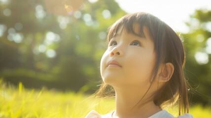 Fototapeta premium Cute little girl looks up 