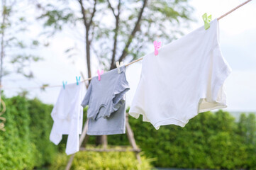 Clothes hanging laundry on washing line for drying against blue sky outdoor