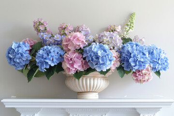 A composition of blue hydrangeas and pink peonies, arranged in a ceramic pot on a white shelf.