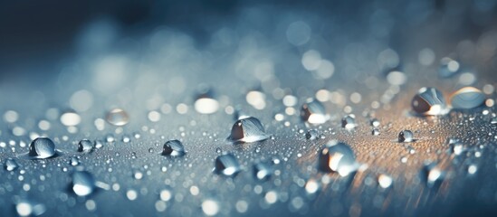 Close up view of water droplets resting on a window, reflecting light and creating a shimmering effect. The droplets vary in size and shape, adding texture to the glass surface. - obrazy, fototapety, plakaty