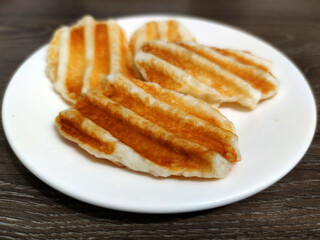 Greek halloumi cheese grilled on a white plate