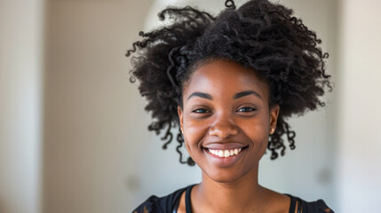 Radiant African American woman with afro curls smiling confidently
