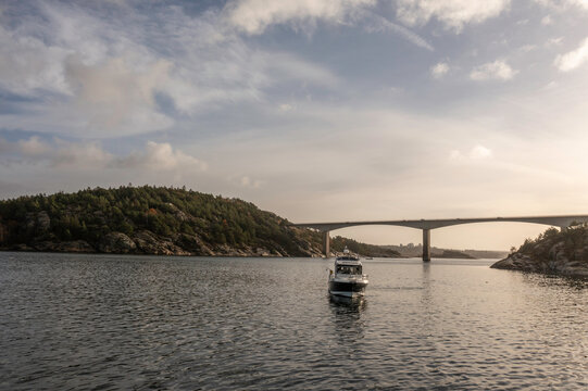 Fishing boat crossing under a bridge