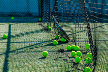 Bright tennis balls on a sunlit court, casting dramatic shadows. Perfect for sports themes