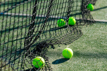 Tennis balls and net on court