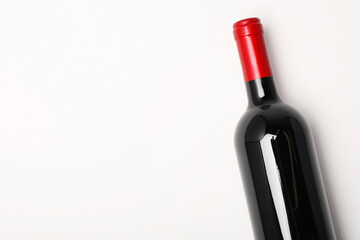 Bottle of expensive red wine on white background, top view. Space for text