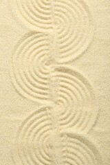 Fototapeta na wymiar Zen rock garden. Wave pattern on beige sand, top view