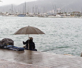 fishing under the rain in the gulf of la spezia