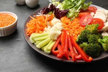 Balanced diet and healthy foods. Plate with different delicious products on black table, closeup