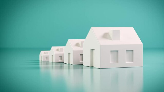 Which size of house can you afford? Concept shot: four differently sized models of houses on a turquoise blue background. Moving camera.