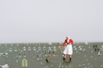 Woman cleaning an electronic circuit board, miniature figures scene