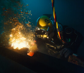 Commercial diver welding underwater at construction site - 751706331