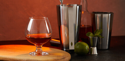 Set of barman equipment and cocktail on wooden table during cocktail preparation. Alcoholic cocktail drink.