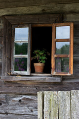 Rustic window in wooden village cottage house. Wood wall.