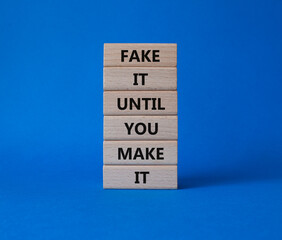 Fake it until you make it symbol. Concept words Fake it until you make it on wooden blocks. Beautiful blue background. Business concept. Copy space.
