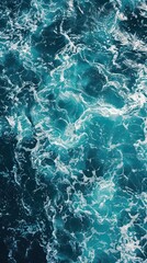 Fototapeta na wymiar Blue sea water background. Top view of ocean surface with waves.