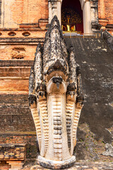 Crowned Nagas flank the stairs of Wat Chedi Luang a main attraction in the city of Chiang Mai. Construction of the Wat began in the 14th century but was only completed in the midd of the 15th century