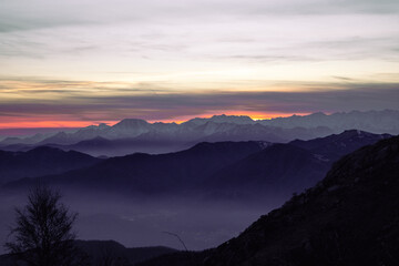 Staring at the horizon. Mountain range silhouette. Suggestive sunset over the alps, from Mottarone...