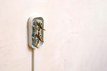 Disassembled electrical outlet on the wall