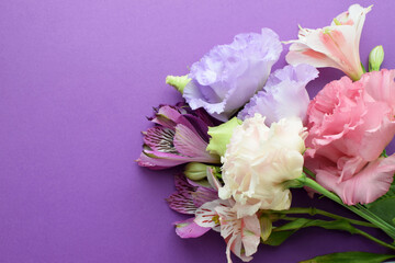 Beautiful flowers of eustoma (lisianthus) and alstroemeria. Bouquet of flowers on a lilac background. Copy space