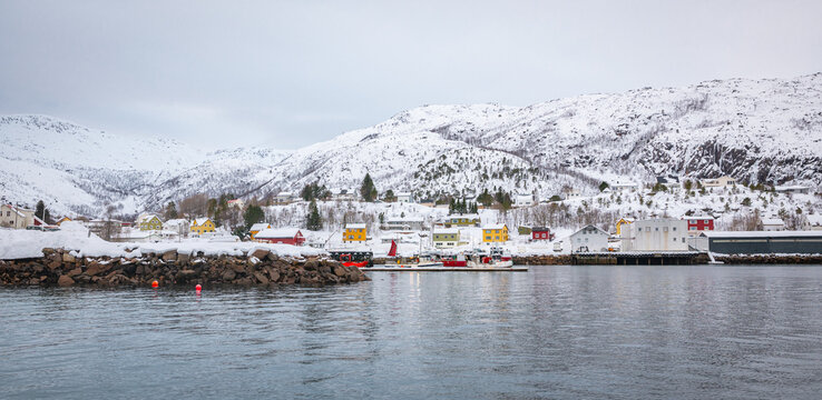 Panoramic winter view of traditional yellow and red colored Norwegian houses along the waterfront in the town of L&oslash;dingen, Norway