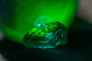 Transparent green stone with glowing textured background