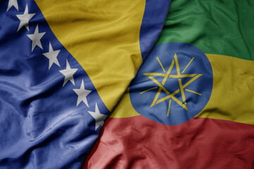 big waving national colorful flag of ethiopia and national flag of bosnia and herzegovina.
